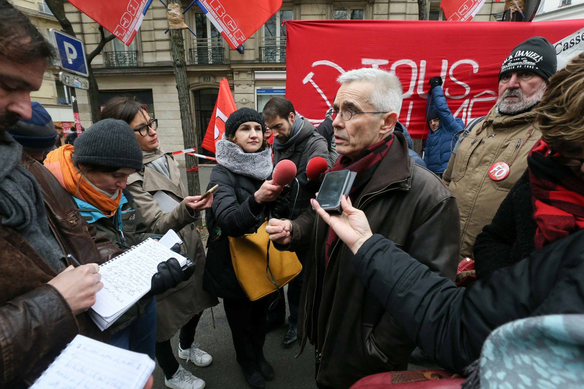 Secretary-General of the French Union Force Ouvriere (FO) Yves Veyrier (C) talks with the press during a demontration to protest against the pension overhauls, in Paris, on December 5, 2019 as part of a national general strike. Trains cancelled, schools cl Secretary-General of the French Union Force Ouvriere (FO) Yves Veyrier (C) talks with the press during a demontration to protest against the pension overhauls, in Paris, on December 5, 2019 as part of a national general strike. Trains cancelled, schools cl