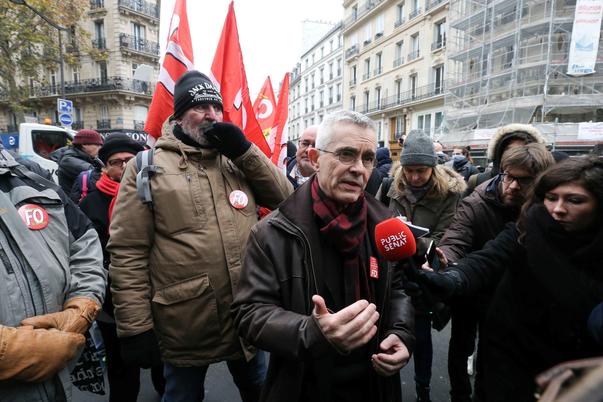 Secretary-General of the French Union Force Ouvriere (FO) Yves Veyrier (C) talks with the press during a demontration to protest against the pension overhauls, in Paris, on December 5, 2019 as part of a national general strike. Trains cancelled, schools cl Secretary-General of the French Union Force Ouvriere (FO) Yves Veyrier (C) talks with the press during a demontration to protest against the pension overhauls, in Paris, on December 5, 2019 as part of a national general strike. Trains cancelled, schools cl