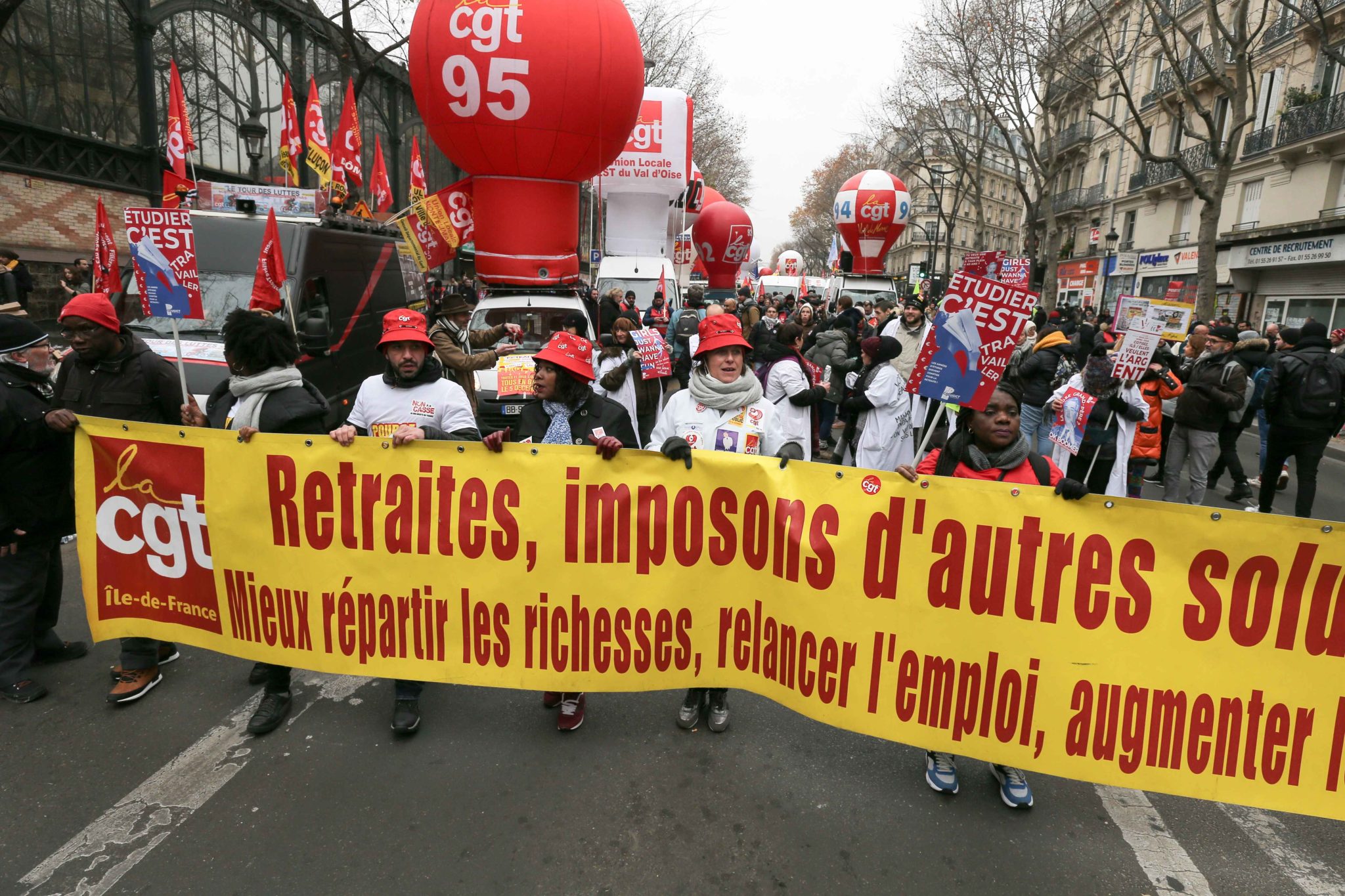 Protesters hold a banner reading « Pensions : impose other solutions » during a demontration to protest against the pension overhauls, in Paris, on December 5, 2019 as part of a national general strike. Trains cancelled, schools closed: France scrambled Protesters hold a banner reading « Pensions : impose other solutions » during a demontration to protest against the pension overhauls, in Paris, on December 5, 2019 as part of a national general strike. Trains cancelled, schools closed: France scrambled