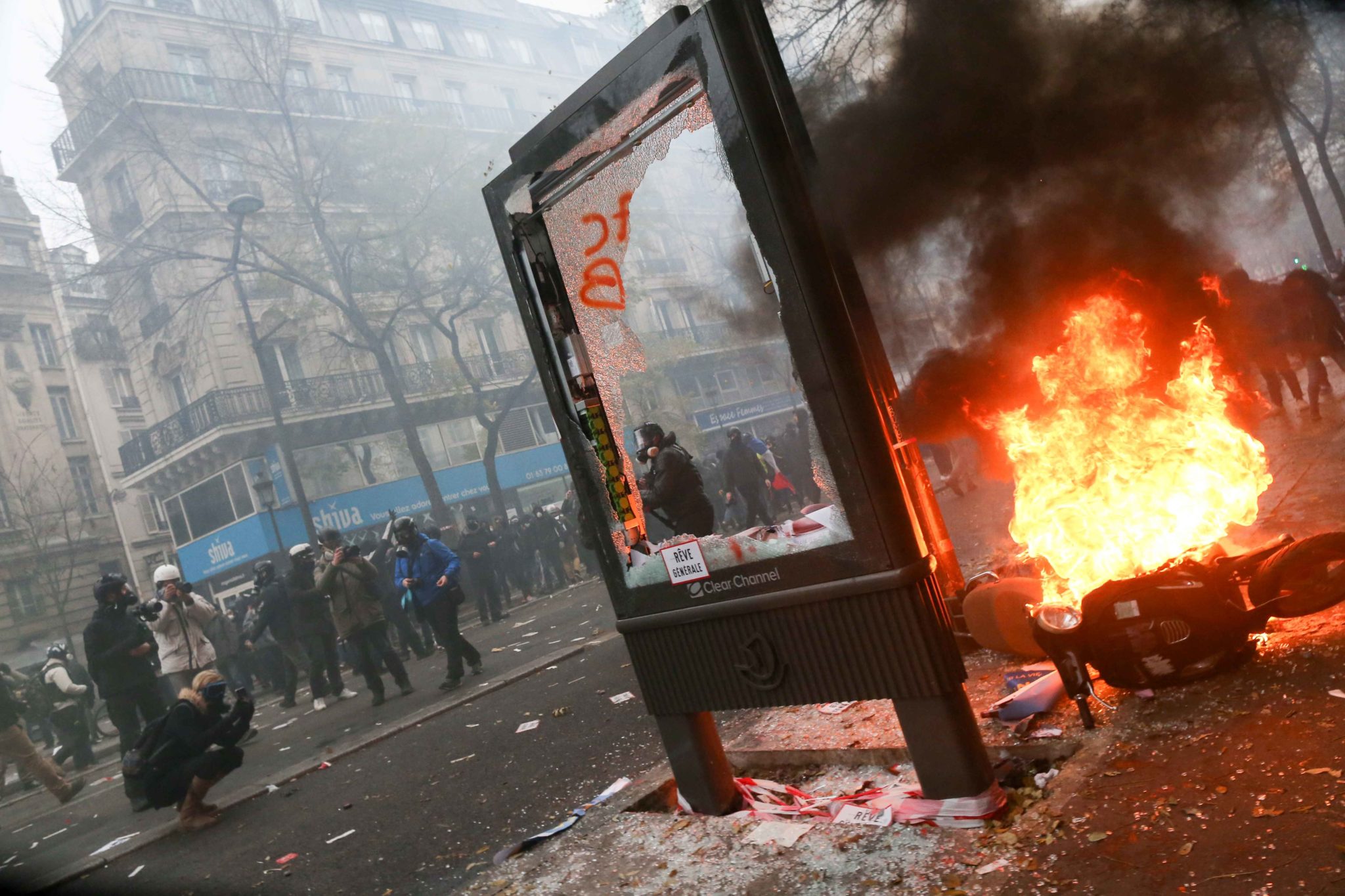 A publicity pane is destroyed and a scooter set on fire during a demontration to protest against the pension overhauls, in Paris, on December 5, 2019 as part of a national general strike. Trains cancelled, schools closed: France scrambled to make contingen A publicity pane is destroyed and a scooter set on fire during a demontration to protest against the pension overhauls, in Paris, on December 5, 2019 as part of a national general strike. Trains cancelled, schools closed: France scrambled to make contingen